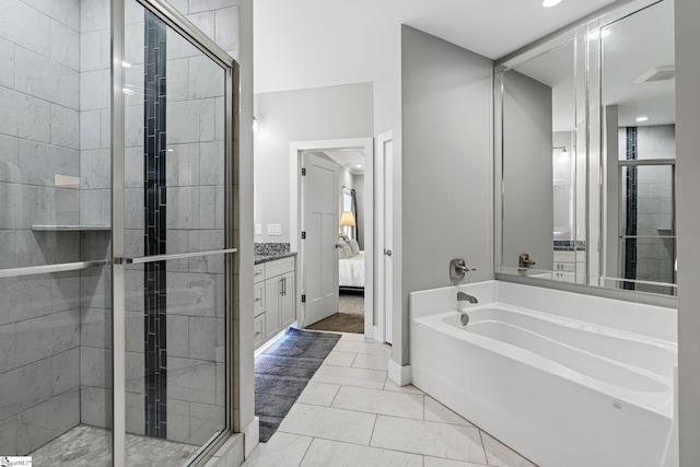 bathroom featuring vanity, shower with separate bathtub, and tile patterned flooring