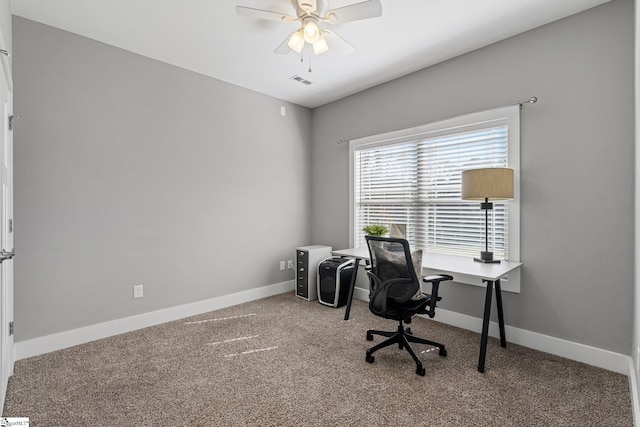 carpeted office space featuring ceiling fan