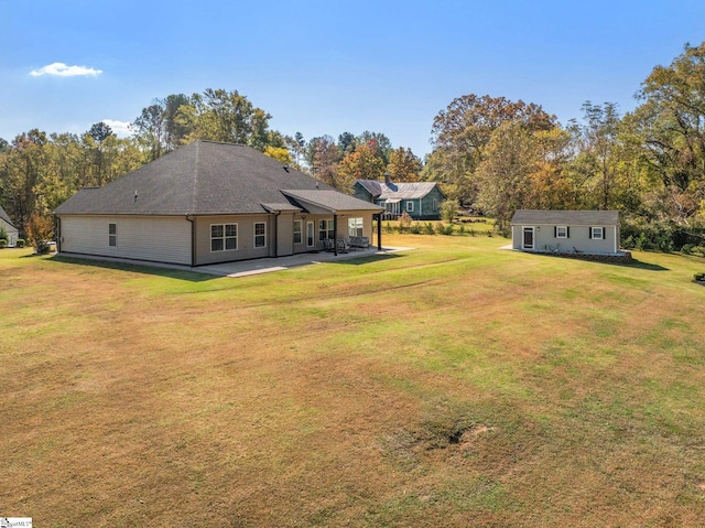 back of house featuring a patio and a lawn