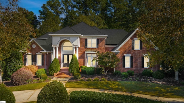 view of front of house featuring a front yard and french doors