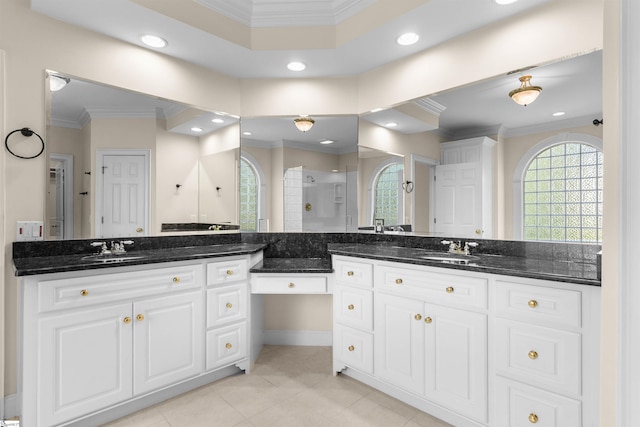 bathroom with vanity, crown molding, a shower with shower door, and tile patterned flooring