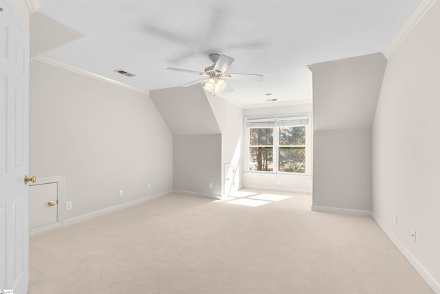 additional living space featuring vaulted ceiling, light carpet, and ceiling fan