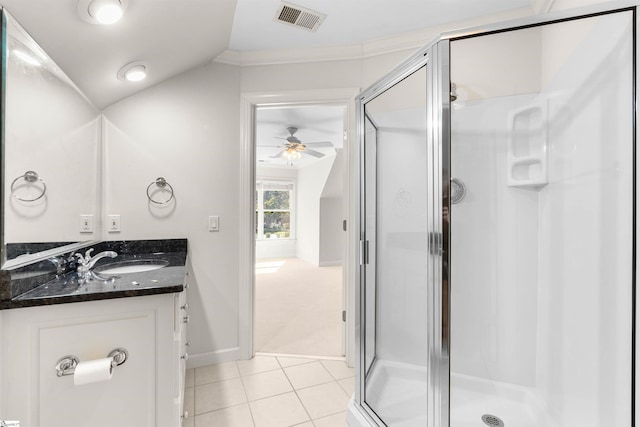 bathroom featuring ceiling fan, vaulted ceiling, vanity, an enclosed shower, and tile patterned flooring