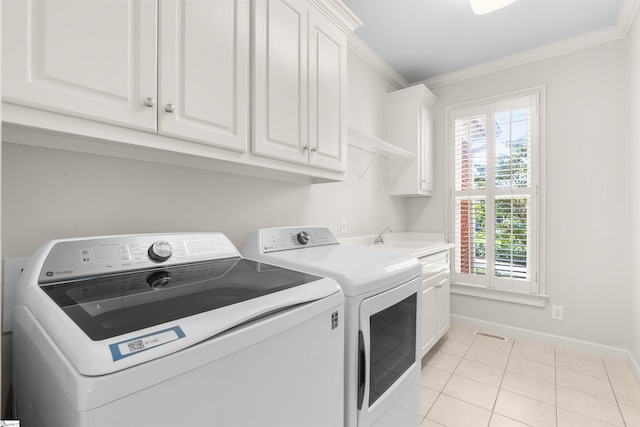 washroom with independent washer and dryer, crown molding, and a wealth of natural light