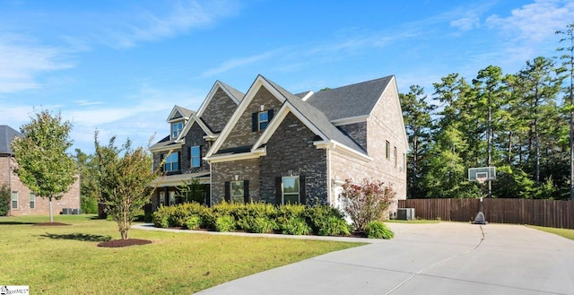 view of front facade featuring a front lawn and central AC unit