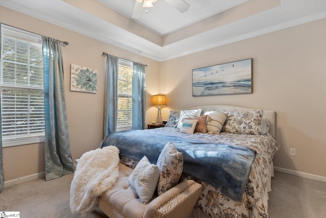 carpeted bedroom with ornamental molding and ceiling fan