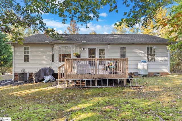 rear view of property featuring a wooden deck, a yard, and central air condition unit