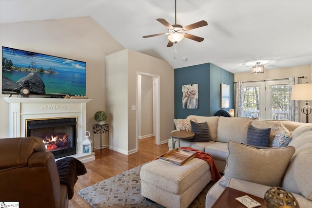 living room with vaulted ceiling, light hardwood / wood-style floors, and ceiling fan