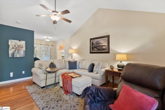 living room featuring lofted ceiling, wood-type flooring, and ceiling fan