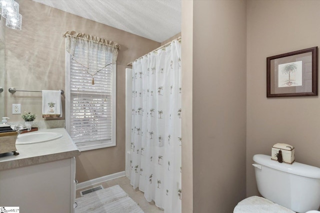 bathroom featuring tile patterned floors, toilet, a shower with shower curtain, vanity, and a textured ceiling