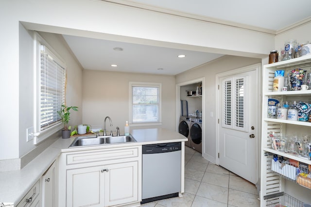 kitchen with dishwasher, washer and clothes dryer, kitchen peninsula, sink, and white cabinetry