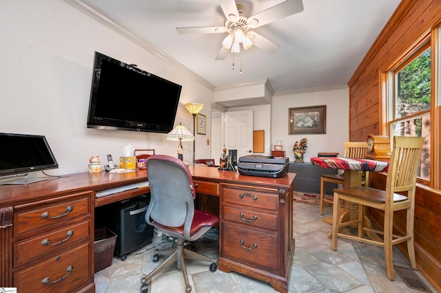 home office with ceiling fan, crown molding, and wood walls