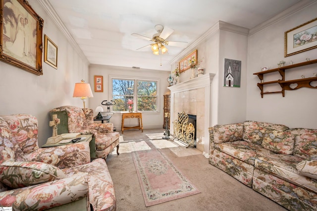 living room featuring ceiling fan, crown molding, light carpet, and a tiled fireplace