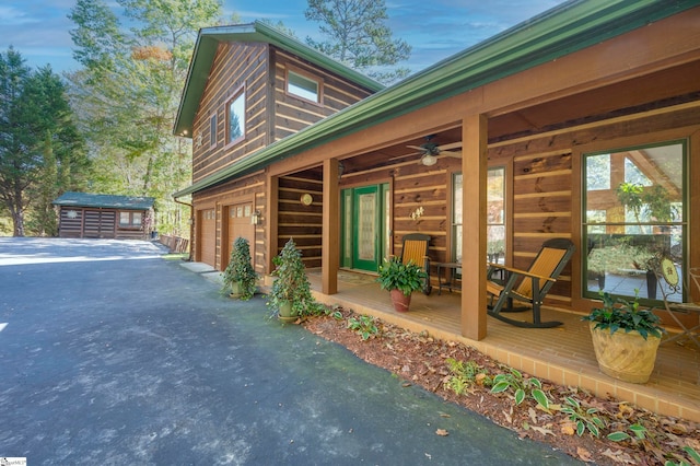 view of home's exterior featuring a storage unit and a garage