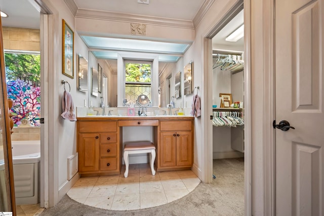 bathroom with crown molding, a washtub, vanity, and tile patterned flooring