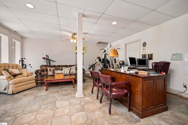 home office with a drop ceiling and ceiling fan