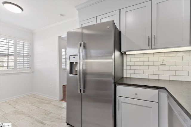 kitchen featuring appliances with stainless steel finishes, decorative backsplash, and ornamental molding