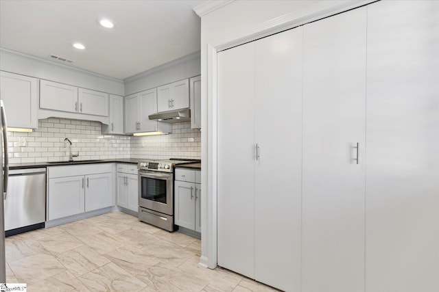 kitchen featuring ornamental molding, sink, appliances with stainless steel finishes, and backsplash