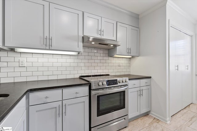 kitchen featuring dark stone countertops, backsplash, ornamental molding, and stainless steel electric range oven