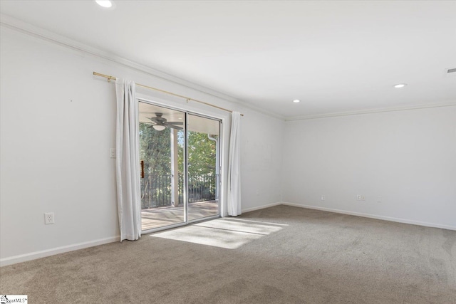 carpeted empty room with crown molding and ceiling fan