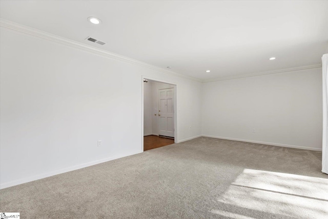 unfurnished room with crown molding and carpet