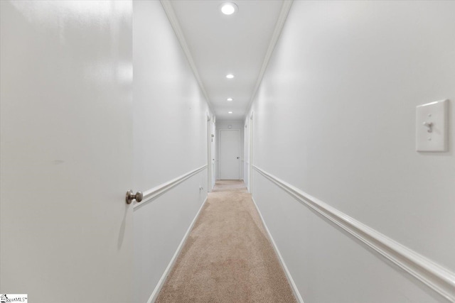 hall featuring light carpet and crown molding