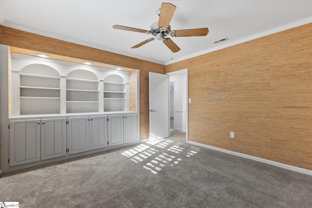 carpeted spare room with ornamental molding and ceiling fan