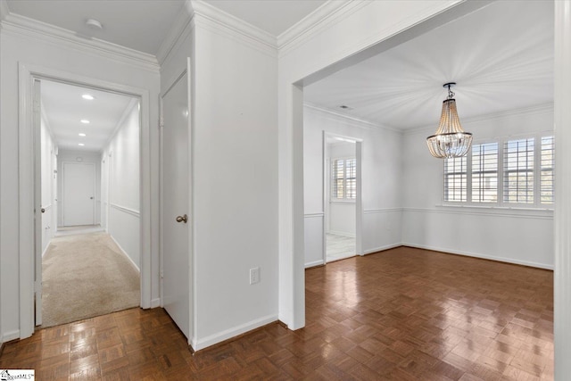 interior space featuring a wealth of natural light, crown molding, and an inviting chandelier