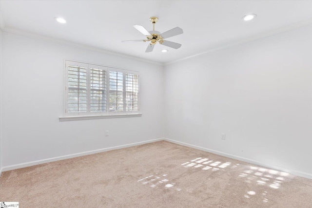 spare room with ornamental molding, carpet floors, and ceiling fan