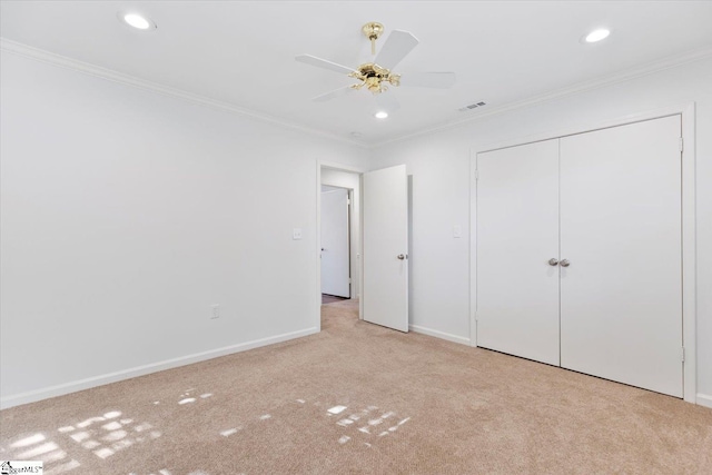 unfurnished bedroom with a closet, crown molding, and ceiling fan