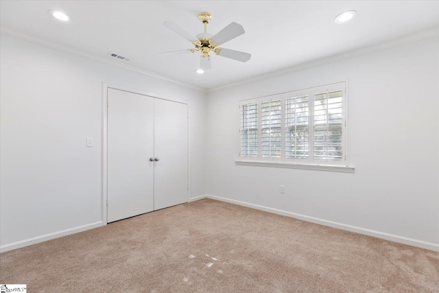 unfurnished bedroom featuring ornamental molding, a closet, and ceiling fan