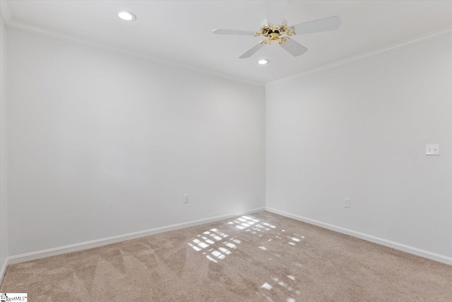 carpeted empty room with crown molding and ceiling fan