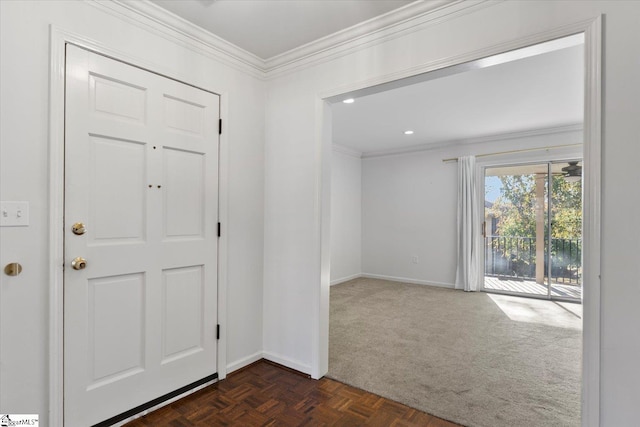 entrance foyer with crown molding and dark carpet