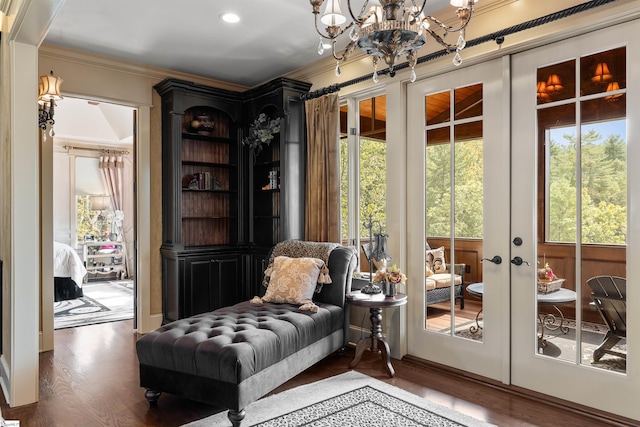 doorway featuring ornamental molding, french doors, a notable chandelier, and dark hardwood / wood-style flooring