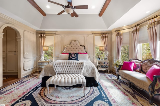 bedroom with lofted ceiling with beams, dark hardwood / wood-style floors, and ceiling fan