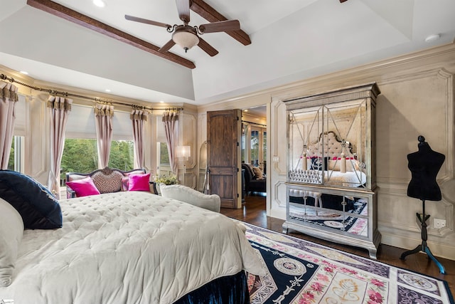 bedroom featuring dark hardwood / wood-style flooring, lofted ceiling, and ceiling fan