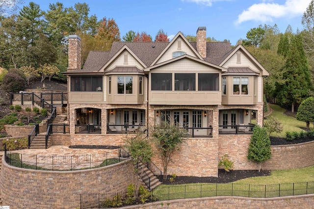 rear view of property featuring a sunroom