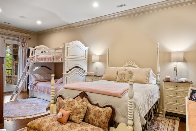 bedroom featuring ornamental molding, hardwood / wood-style flooring, and access to outside