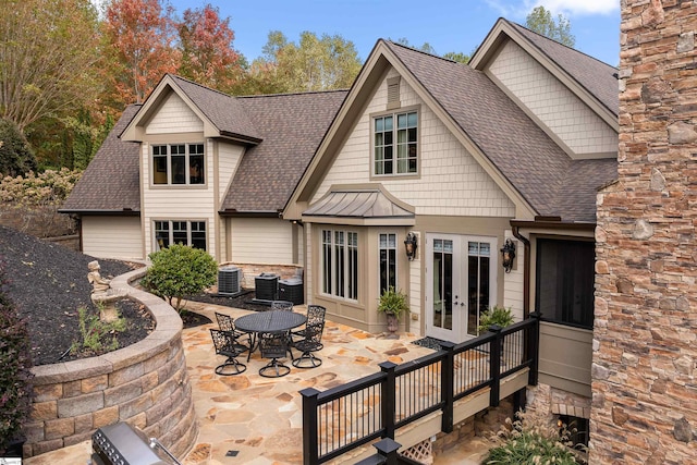 rear view of house with a patio, french doors, and central AC unit