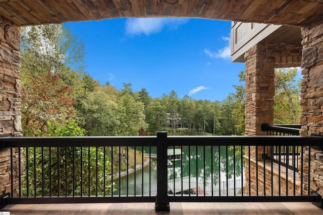 wooden terrace featuring a water view