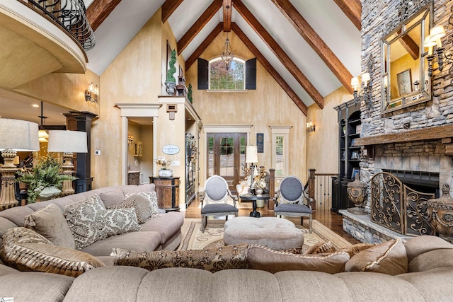 living room with beam ceiling, a fireplace, hardwood / wood-style flooring, and high vaulted ceiling