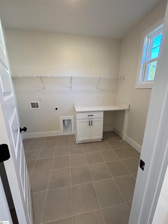 clothes washing area with hookup for an electric dryer, washer hookup, and tile patterned floors