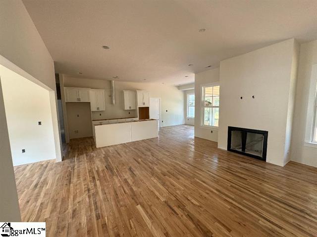 unfurnished living room with wood-type flooring