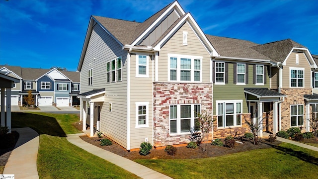 view of property featuring a garage and a front lawn