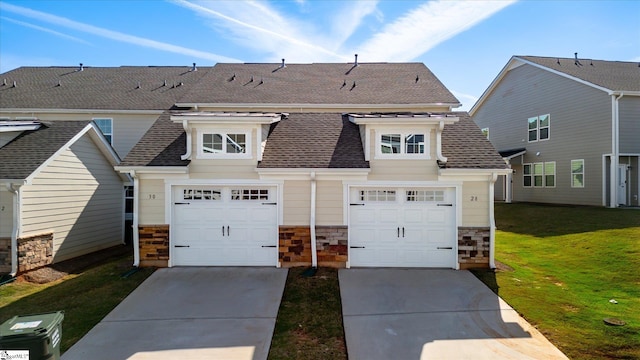 view of front of home with a garage and a front lawn