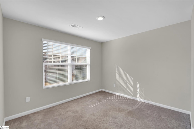 unfurnished room with light carpet