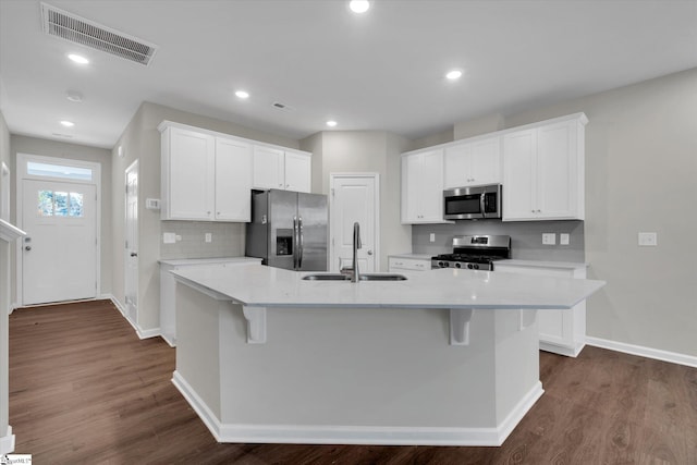 kitchen with a center island with sink, white cabinets, stainless steel appliances, and sink