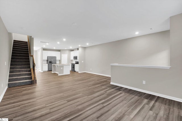 unfurnished living room with hardwood / wood-style flooring