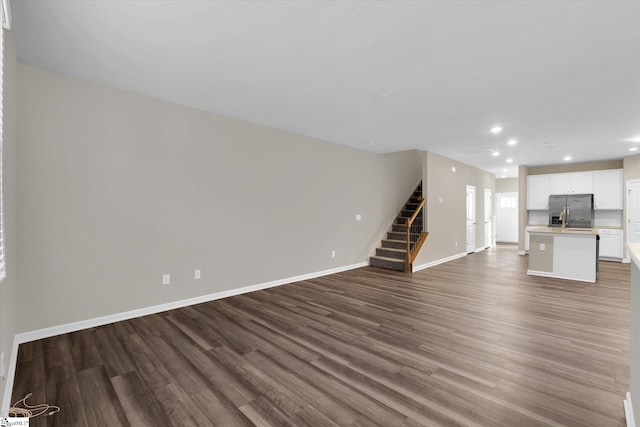 unfurnished living room featuring hardwood / wood-style floors