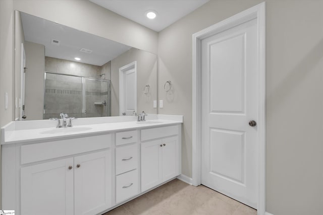 bathroom with vanity, a shower with shower door, and tile patterned flooring